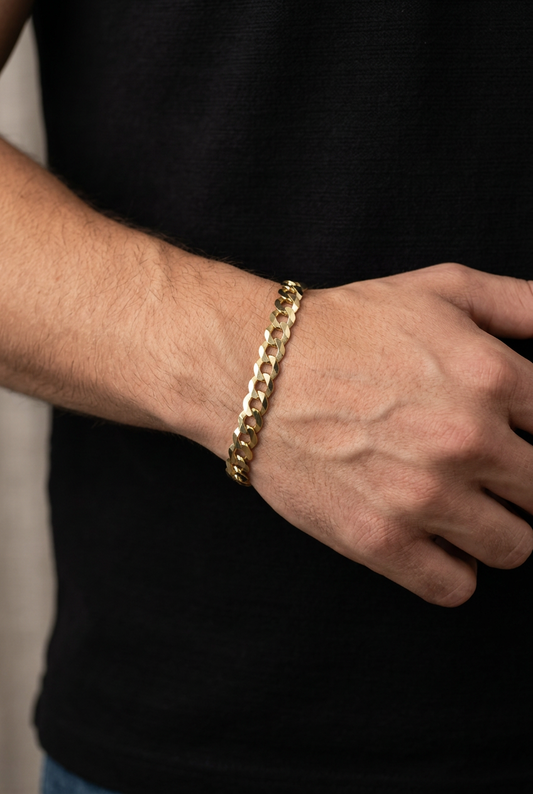 Original gold curb bracelet featured on a male model’s wrist