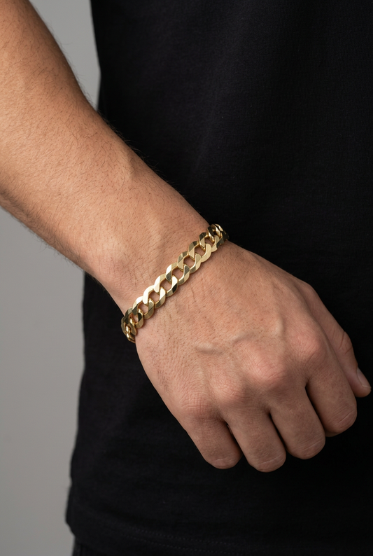 Original gold curb-link bracelet on a male model’s wrist